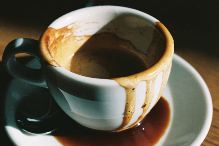 Crema thinning at the edge of a small cup of espresso