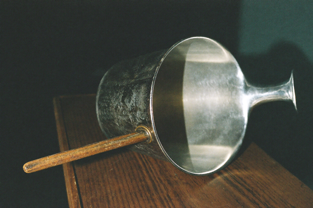 A copper cezve tipped to show the bright tin lining inside