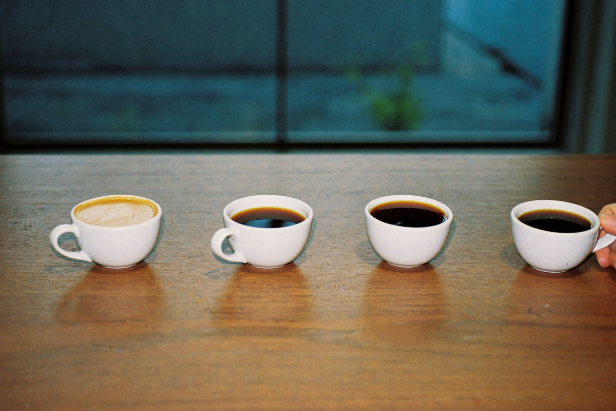 Four cups of coffee in a row, each a different depth of brown